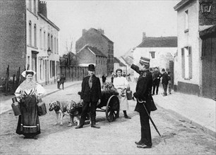 Daily life in Antwerp, Belgium, muzzled dogs pulling a small cartca. between 1909 and 1919