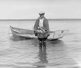 Man shad fishing on the Potomac River ca. between 1909 and 1932
