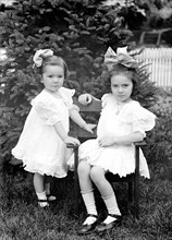 Two young girls posing for a photo ca. between 1909 and 1923