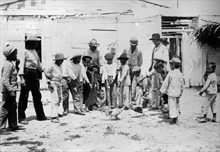 Men and children in Puerto Rico watching a cock fight ca. between 1909 and 1919