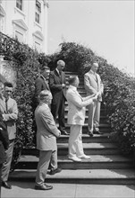 Calvin Coolidge and others on steps of White House ca. between 1909 and 1940