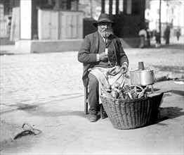 A man in the street selling bread & sausages in Vienna Austria ca. between 1909 and 1920