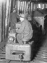 A miner riding on an electric locomotive, Oliver Iron Mining Co., Minnesota ca. between 1909 and 1920