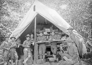 U.S. Army or National Guard troops outside a tent, possibly a temporary commisary ca. between 1909 and 1940