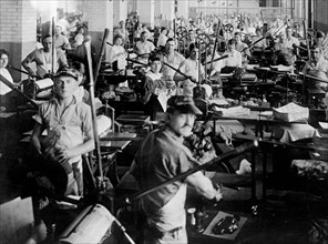 Employees at their workstations at the Bureau of Engraving and Printing ca. between 1909 and 1932