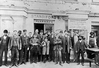 Group of men in front of Standiford's Pharmacy in Washington D.C. ca. early 20th century