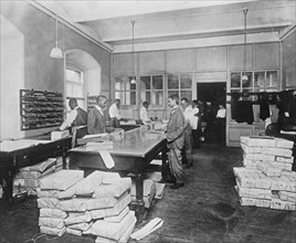 Treasury Department - Workers packing internal revenue stamps for shipment Stamps to the value of $1,000,000 packed daily. ca. between 1909 and 1932