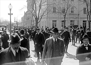 Men walking in a busy street scene, probably in Washington D.C. ca.  1918