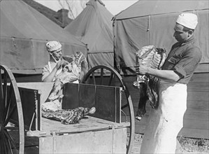 Army kitchen, cooks carrying beef ca.  between 1918 and 1928