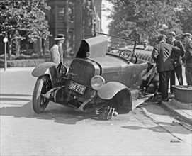 Men at the scene of an auto accident ca.  between 1918 and 1920