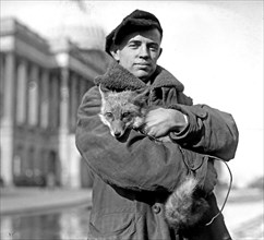 George M. Green holding a fox? ca.  between 1918 and 1920