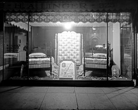 H.A. Linger store window at night, featuring bedding and matresses ca.  between 1918 and 1928