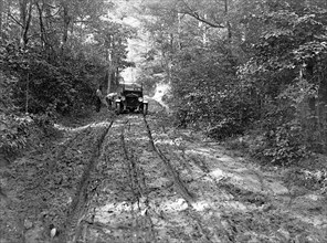 Duplex truck having tired fixed on a backwoods road ca.  between 1918 and 1921