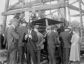 Potomac Gas & Fuel Company, men surround an oil derrick ca.  between 1918 and 1921