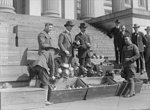 Men unloading helmets for victory loan ca.  between 1918 and 1920