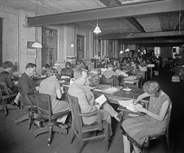 Workers at the office of the National Farm News, interior ca.  between 1918 and 1928