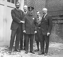 Policeman at the British Embassy, with embassy officials ca.  between 1918 and 1920