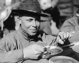 U.S. Army soldier in the trenches eating his rations ca.  between 1918 and 1928