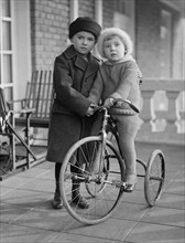 Child riding a tricycle ca.  1923