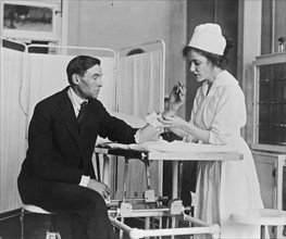 Public Health Service nurse treating a patient ca.  1918