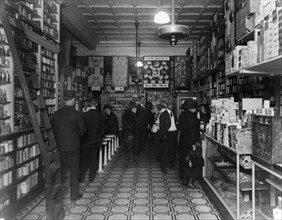 Interior of back of People's Drug Store, 14th and U(?) Streets, Washington, D.C., with employees and customers, some seated at soda fountain ca. between 1909 and 1932