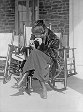 Miss Sarah Anderson, a Washington suffragist who advocates equal smoking rights for men and women in public places, as she puffs a cigarette at the Chevy Chase Club ca. between 1909 and 1930