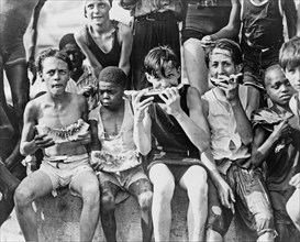 Young kids eating watermelon ca. 1909