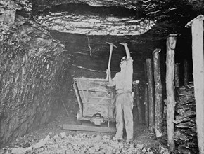 Miner working in coal mine ca. 1909