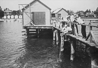 Men fishing from a dock at Colonial Beach, VA ca. 1909