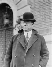Senator Hiram W. Johnson, half-length portrait, standing, facing left, wearing bowler hat ca. 1909