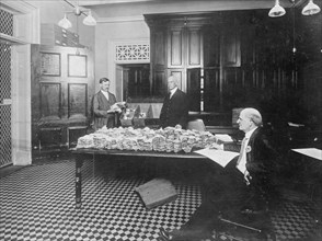 Office of Comptroller.  Committee checking daily destruction of National Bank notes ca. 1909