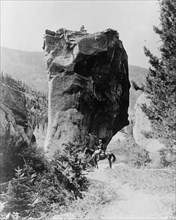 Man on horseback by butte in Rocky Mountain National Park, Colorado ca. 1909