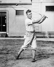 Man swinging golf club in the Washington, D.C., area ca. 1909