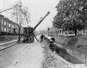 Crane, owned by the District of Columbia Water Department, Washington, D.C., being used to lay pipe ca. 1909
