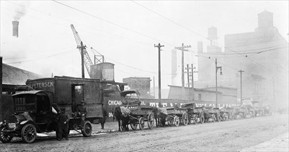 Coal wagons waiting in line 6 blocks long to get coal at one of the largest coal yards in Chicago ... ca. 1909