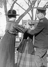 Training a policewoman--Inspector Cross and Miss Clark, veteran policewoman, are shown demonstrating the correct way to handcuff a prisoner ca. 1909