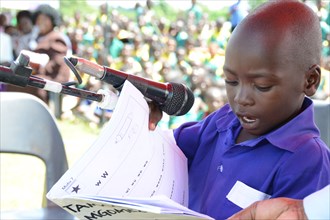 In Malawi, a young primary school student demonstrates his reading ability ca. 17 July 2012