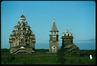 Pogost ensemble, Church of the Transfiguration (1714) (left); bell tower (19th century); Church of the Intercession (1764), west view, evening, Kizhi Island, Russia; 1993