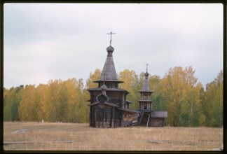 Log Church of the Savior and bell tower from the village of Zashiversk (1700), east view, moved and reassembled in the Outdoor Architecture and History Museum at Akademgorodok, Russia; 1999