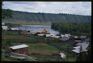 Log houses, with Belaia River in background, Bel'sk, Russia; 2000