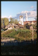 Church of the Trinity (1703-12), northwest panorama, with log houses (19th-20th centuries), and garden plots in foreground, Verkhotur'e, Russia 1999.