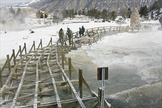 Workers removing boardwalk at Palette Spring in Mammoth Hot Springs in Yellowstone National Park;  Date: 16 February 2006