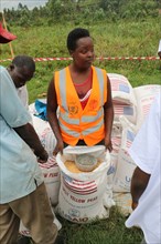 A relief worker with a bag of yellow peas offers assistance in North Kivu Cote d’Ivoire (ivory Coast) ca. 22 March 2017