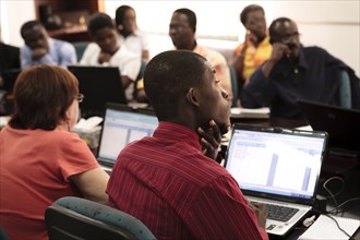 West African men and women gaining professional skills in accounting class  ca. 28 July 2010