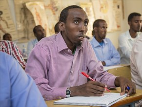 A man listens intently during a teacher training session in Mogadishu or Garowe via the "Somali Youth Learners Initiative (SYLI)"  ca. 11 June 2015
