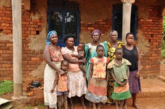 A household of four generations outside a building, possibly a home, in  Busakila sub-county Uganda ca. 6 March 2018