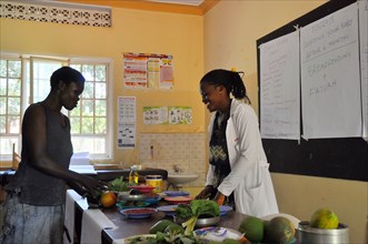 One caregiver moves foods into categories based on how they impact their child's growth and development during an interactive portion of a cooking demonstration ca. 7 March 2018