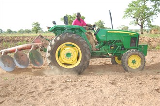 AA Ataqwaah riding his new John Deere tractor on his farm (probably in Ghana) ca. 9 April 2015
