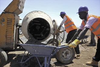 Construction site workers in last minute preparations at the project site in Kenya ca. 28 January 2014