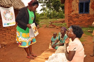 Susan, a VHT in the Busakila sub-county (Uganda) educates a family on key health behaviors as part of the Wheel of Better Health ca. 6 March 2018